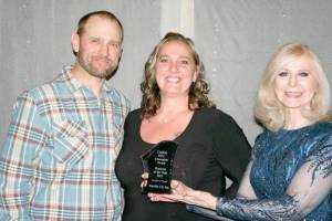 Accepting the Clallam Economic Development Council Champion Award Business of the Year award from Cherie Kidd of AAA Affordable Storage, award sponsor, right, were Interfor US, Inc.'s management team members Tyril Spence, left, and Chandra McGoff.