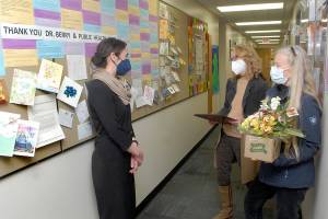 Allison Berry, public health officer for Clallam and Jefferson counties, left, talks with Marcia Limoges, center, and Bonnie Bless-Boenish of the League of Women Voters of Clallam County before presenting Berry with the organizations annual Making a Difference Award on Tuesday in Port Angeles. Presented in celebration of womens contributions to history and coinciding with Womens History Month, the award was given to Berry for her contributions to public health during the COVID-19 pandemic. (Keith Thorpe/Peninsula Daily News)