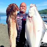 Olympic Chapter of Salmon for Soliders member Daniel Goettling caught this halibut and lingcod while fishing with a group of military veterans last summer. Halibut fishing begins April 7 in Marine Areas 6-10.