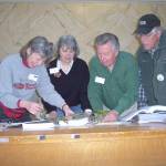 Clallam County master gardeners, from left to right, Jeanette Stehr-Green, Cindy Erickson, Nye Nelson and John Norgord discussing a problem with a hemlock tree during a plant clinic.