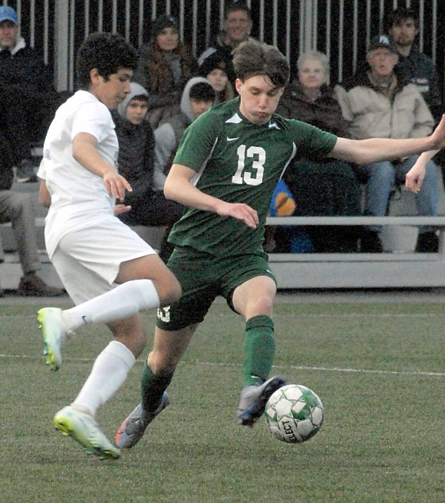 Keith Thorpe/Peninsula Daily News Port Angeles Caden White, right, battles for the ball with Olympics Chris Ramirez on Thursday evening in Port Angeles.