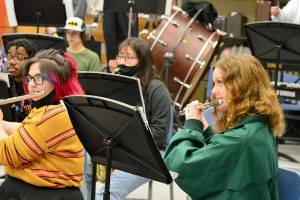 After many months of masking, flutists Gabby Mattern-Hall, left, and Sibyl Finman got to shed their face coverings for band practice earlier this month in George Rodes band room. (Diane Urbani de la Paz/Peninsula Daily News)