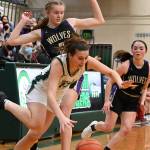 Sequim's Jolene Vaara, left, and Hannah Bates pressure Port Angeles' Bailee Larson in the first half of a West Central District playoff game in February in Port Angeles. All three players made the first all-Olympic girls basketball team. (Michael Dashiell/Olympic Peninsula News Group)