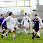 Sequims Ethan Knight, right, is surrounded by Bainbridge defenders near the Spartans goal box during the Wolves 3-0 loss on Tuesday. (Michael Dashiell/Olympic Peninsula News Group)