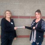Heidi Albrecht, left, treasurer for Coats for Kids, receives a check from Cheryl Stipe of Jim’s Pharmacy.