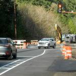 Traffic waits at a temporary stoplight controlling a one-lane temporary bridge that bypasses a construction zone on U.S. Highway 101 at Indian Creek west of Port Angeles on Saturday. (Keith Thorpe/Peninsula Daily News)