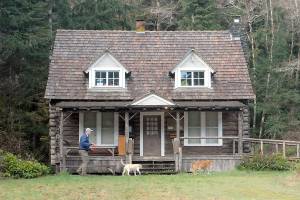 Matthew Carter of Sequim walks his dogs Roxie and Izaak, right, past the Storm King Ranger Station at Barnes Point near the shore of Lake Crescent in Olympic National Park on Saturday. The Barnes Point area is home to the Lake Crescent Lodge, which is open weekends and then daily beginning April 29, as well as the NatureBridge environmental science park and the trailhead to Marymere Falls. (Keith Thorpe/Peninsula Daily News)