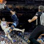 Kansas guard Ochai Agbaji (30) shoots as Villanova forward Eric Dixon defends during the second half of a college basketball game in the semifinal round of the Men's Final Four NCAA tournament, Saturday, April 2, 2022, in New Orleans. (AP Photo/Brynn Anderson)