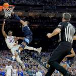 Kansas guard Ochai Agbaji (30) shoots as Villanova forward Eric Dixon defends in the semifinal round of the Mens Final Four NCAA tournament Saturday in New Orleans. (Brynn Anderson/The Associated Press)