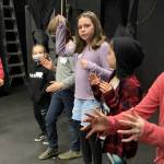 Young theater students read and direct each other in creating the factory machines that create candy, in preparing Charlie and the Chocolate Factory for April 9 performances. (Sarah Tucker and Marissa Meek)