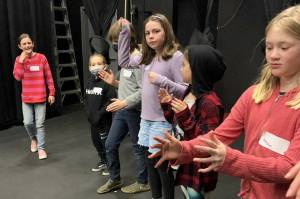 Young theater students read and direct each other in creating the factory machines that create candy, in preparing Charlie and the Chocolate Factory for April 9 performances. (Sarah Tucker and Marissa Meek)