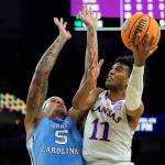 Kansas guard Remy Martin shoots around North Carolina forward Armando Bacot during the second half of a college basketball game in the finals of the Men's Final Four NCAA tournament, Monday  in New Orleans. (AP Photo/David J. Phillip)