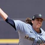 Seattle Mariners starting pitcher Logan Gilbert throws during the first inning of a spring training baseball game against the Kansas City Royals Tuesday, March 29, 2022, in Peoria, Ariz. (Charlie Riedel/The Associated Press)