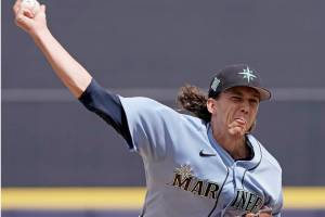 Seattle Mariners starting pitcher Logan Gilbert throws during the first inning of a spring training baseball game against the Kansas City Royals Tuesday, March 29, 2022, in Peoria, Ariz. (Charlie Riedel/The Associated Press)