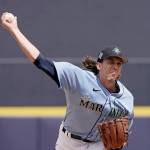 Seattle Mariners starting pitcher Logan Gilbert throws during the first inning of a spring training baseball game against the Kansas City Royals Tuesday, March 29, 2022, in Peoria, Ariz. (Charlie Riedel/The Associated Press)