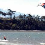 Barney Lund of Kent takes to the water off Dungeness Bay with his kite board on a blustery Tuesday north of Sequim. Stiff westerly breezes prompted Lund to try his hand at harnessing the wind, he said. (Keith Thorpe/Peninsula Daily News)