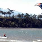 Barney Lund of Kent takes to the water off Dungeness Bay with his kite board on a blustery Tuesday north of Sequim. Stiff westerly breezes prompted Lund to try his hand at harnessing the wind, he said. (Keith Thorpe/Peninsula Daily News)