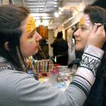 Keith Thorpe/Peninsula Daily News
Soohia Art of Port Angeles, right, gets her face painted by Emma Gockerell of Sequim-based Emma-gine Painting & Parties during Friday's pop-up market at the inaugural Squatchcon 2022 Comic & Arts Convention at The Wharf on the Port Angeles waterfront. The convention continues today and Sunday with a variety of activities.