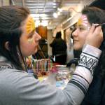Soohia Art of Port Angeles, right, gets her face painted by Emma Gockerell of Sequim-based Emma-gine Painting & Parties during Fridays pop-up market at the inaugural Squatchcon 2022 Comic & Arts Convention at The Wharf on the Port Angeles waterfront. (Keith Thorpe/Peninsula Daily News)