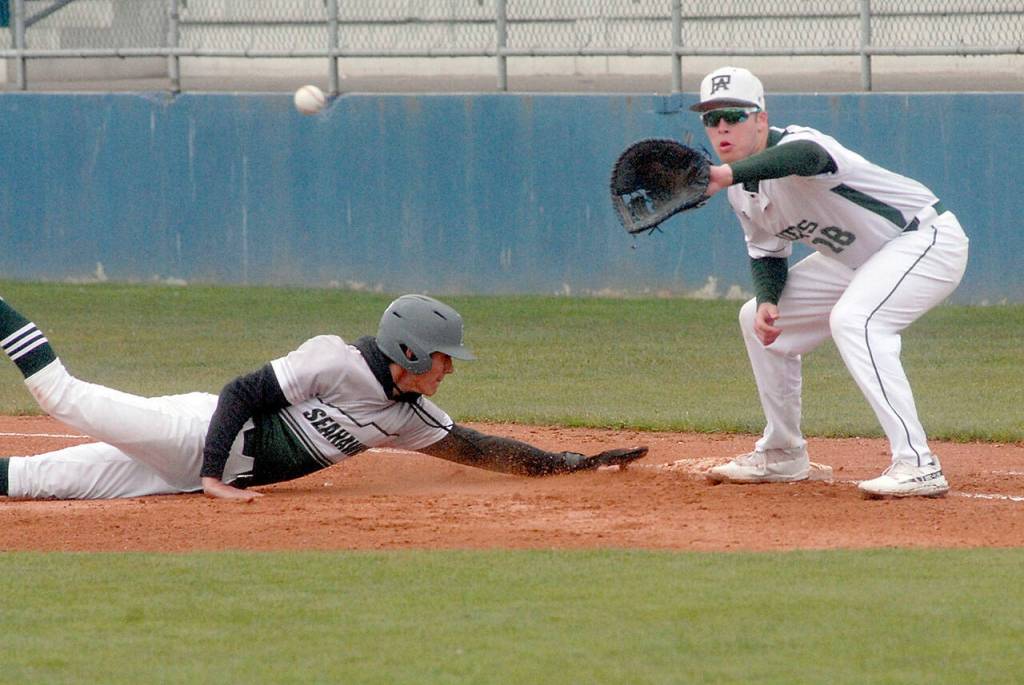 Port Angeles first baseman Cole Johnson, left, receives the throw in an attempt to catch Peninsula baserunner Dakota Ortwein off the bag in the first inning on Friday in Port Angeles. (Keith Thorpe/Peninsula Daily News)