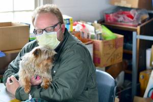 Ben Casserd keeps his terrier Half Pint close by as he manages downtown Port Townsends Winter Welcoming Center. (Diane Urbani de la Paz/Peninsula Daily News)