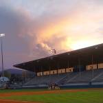 The sun sets behind storm clouds as the Sequim baseball team meets at Port Angeles Civic Field at the conclusion of Monday nights baseball game.	(Pierre LaBossiere/Peninsula Daily News)