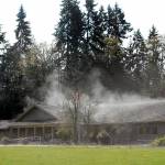 Keith Thorpe/Peninsula Daily News
Steam rises from the roof and front driveway of the Olympic National Park Visitor Center on Thursday in Port Angeles after direct sunlight reached its rain-drenched shingles. Unsettled weather and below-normal temperatures are expected into next week in most areas of the North Olympic Peninsula.