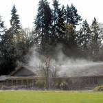 Steam rises from the roof and front driveway of the Olympic National Park Visitor Center on Thursday in Port Angeles after direct sunlight reached its rain-drenched shingles. (Keith Thorpe/Peninsula Daily News)