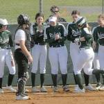 Keith Thorpe/Peninsula Daiulty News
Port Angeles' Lily Halberg, right center, is greeted by her teammates as she crosses home plate after a solo home run, the second of the first inning while Kingston catcher Audrey Rienstra looks on during Thursday's game in Port Angeles.