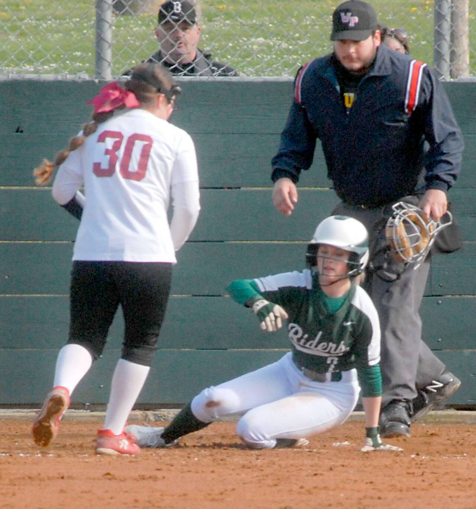 Port Angeles baserunner Peyton Rudd looks towards Kingston pitcher Jayla Moon while stealing home after a wild pitch got away from the catcher on Thursday in Port Angeles. Keith Thorpe/Peninsula Daily News