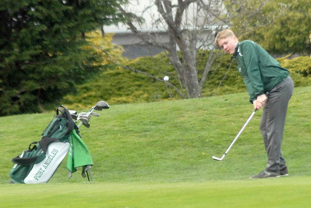 Port Angeles Nate Anderson makes an approach shot to the green on the first hole on Friday against Sequim at Peninsula Golf Club. (Keith Thorpe/Peninsula Daily News)