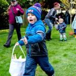 A 4-year-old boy runs excitedly after the perfect Easter egg during the 92nd Port Townsend Elks Lodge Easter Egg Hunt at Chetzemoka Park on Sunday. About 100 kids ages 0-8 scattered to look for decorated eggs, some of which were redeemable for prizes. (Steve Mullensky/for Peninsula Daily News)