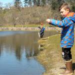 Weston Web, 6, prepares to cast a line at the childrens fishing pond at the Water Reuse Demonstration Site next to Carrie Blake Community Park in March 2021, as his brother, Bennet, 4, tends to a freshly caught fish. (Keith Thorpe/Peninsula Daily News)