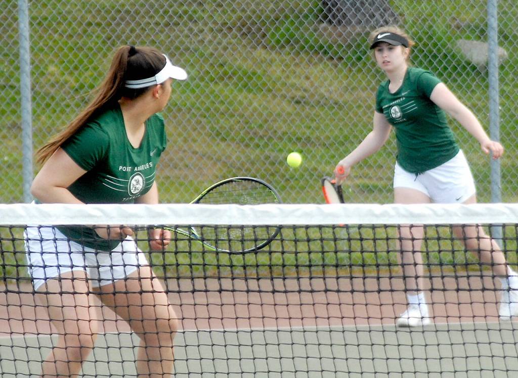 Keith Thorpe/Peninsula Daily News
Port Angeles double team memberes Angelina Sprague, left, and Kinnley Brady compete against the Bainbridge Island team of Emily Knighton and Kristina Walker on Friday at Port Angeles High School.