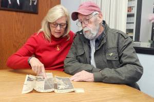 Vicki Parrish of Seven Bays near Davenport, left, discusses the circumstances of a 1987 plane crash she survived on Blyn Mountain with one of her rescuers, Robert Hamlin of Clallam County Search and Rescue, during a reunion in Port Angeles on Tuesday. (Keith Thorpe/Peninsula Daily News)