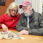 Vicki Parrish of Seven Bays near Davenport, left, discusses the circumstances of a 1987 plane crash she survived on Blyn Mountain with one of her rescuers, Robert Hamlin of Clallam County Search and Rescue, during a reunion in Port Angeles on Tuesday. (Keith Thorpe/Peninsula Daily News)