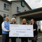 Matthew Nash/Olympic Peninsula News Group
Bret Wirta, owner of the Quality Inn and Suites in Sequim, left, with General Manager Yolanda Pompa and Kaittlyn Reese, assistant general manager, present Betsy Reed Schultz, executive director of the Captain Joseph House Foundation, second from left, $5,000 to help bring families to the Port Angeles home for respite and support. Pompa applied for the grant through the hotel's parent franchise Choice Hotels.
