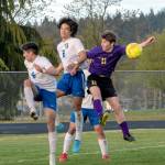 As Knights Aidan Harvey (2) and Diego Clemen (6) defend, Sequims Ethan Knight goes up for a header in the Wolves April 26 home league game against Bremerton. Bremerton won the match 3-1. (Emily Matthiessen/Olympic Peninsula News Group)