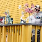 Alisha Teater of Port Angeles watches as her son, William, 14 months, who is fascinated by decorative wind spinners on display on the porch of Pacific Rim Hobby on Saturday in Port Angeles. The pair was on a family shopping excursion with a stop at the hobby store. (Keith Thorpe/Peninsula Daily News)