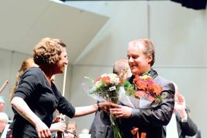 Piano soloist Josu De Solaun, pictured in February 2020 receiving flowers from Port Angeles Symphony volunteer Dorthe Grube Porter, will return as one of the guest artists in the orchestras 90th anniversary season. Tickets for the 2022-2023 series of 13 concerts will go on sale this summer. (Diane Urbani de la Paz/Peninsula Daily News)