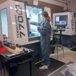 Port Townsend High School senior Haley Jones operates a computer-numeric control (CNC) milling machine, one of the pieces of equipment she learned to use in Tim Behrenfelds computer-integrated manufacturing course. (photo by Tim Behrenfeld)