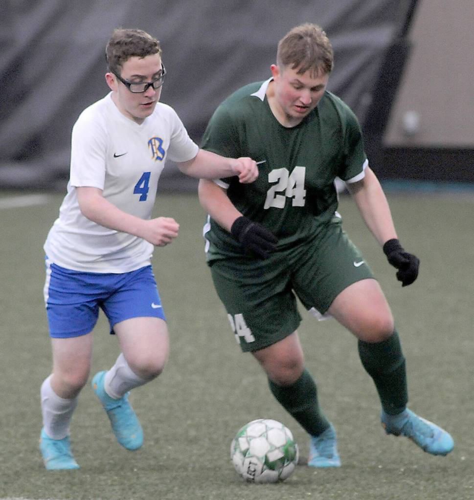 Keith Thorpe/Peninsula Daily News Bremertons Ryan Bell, left, and Port Angeless Eli Fischer meet at midfield during Tuesdays match at Wally Sigmar Field in Port Angeles.