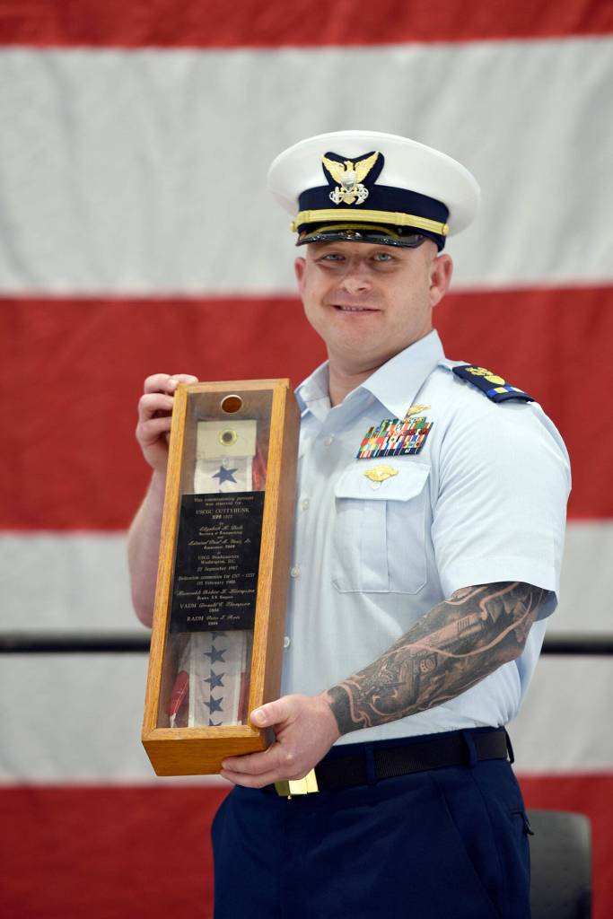 Chief Warrant Officer Daniel Garver received the Coast Guard Cutter Cuttyhunks commissioning pennant during a ceremony held Thursday, May 5, 2022, at Air Station Port Angeles. The ceremony was held to decommission the Cuttyhunk, and Garver, the vessels commanding officer, received the pennant in accordance with tradition. (U.S. Coast Guard photo by Petty Officer 3rd Class Michael Clark)