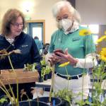 Keith Thorpe/Peninsula Daily News
Peggy DeYoung of Port Angeles, left, talks about plants with Port Angeles Garden Club member Bev Dawson during the group's annual plant sale on Saturday at the Port Angeles Senior Center. The sale featured perennials, annuals, succulents and vegetable starts and served as a fundraiser for garden club activities.