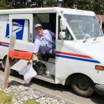 Alex Baker of the USPS picks up some food donations on his west Port Angeles route several years ago. (Dave Logan/For Peninsula Daily News)