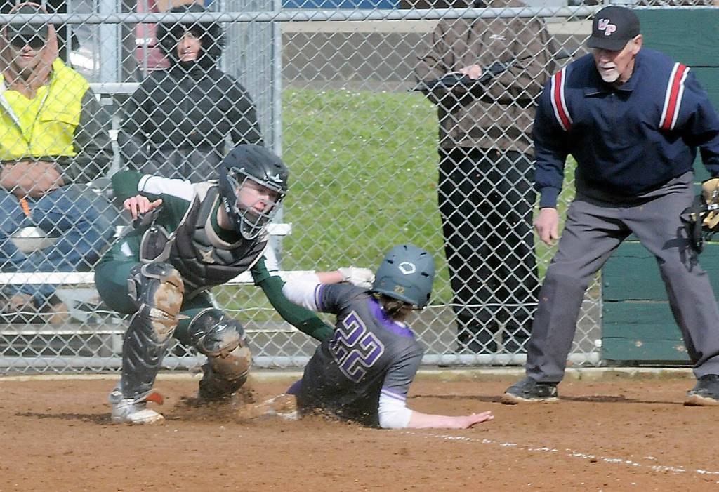 Port Angeles catcher Zoe Smithson, left, tags out North Kitsaps Alison Dovorak at home plate on Thursday in Port Angeles.
Keith Thorpe/Peninsula Daily News