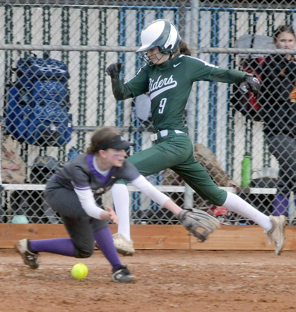 Port Angeles Emi Halberg races to first as North Kitsap first baseman Kasey Wallace bobbles a wild throw on Thursday in Port Angeles.
Keith Thorpe/Peninsula Daily News