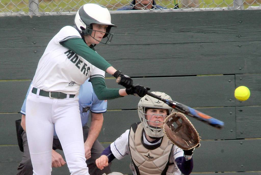 Port Angeles Teagan Clark bats in the second inning as Sequim catcher Christy Grubb waits for the pitch on Friday at the Dry Creek athletic fields in Port Angeles. (Keith Thorpe/Peninsula Daily News)