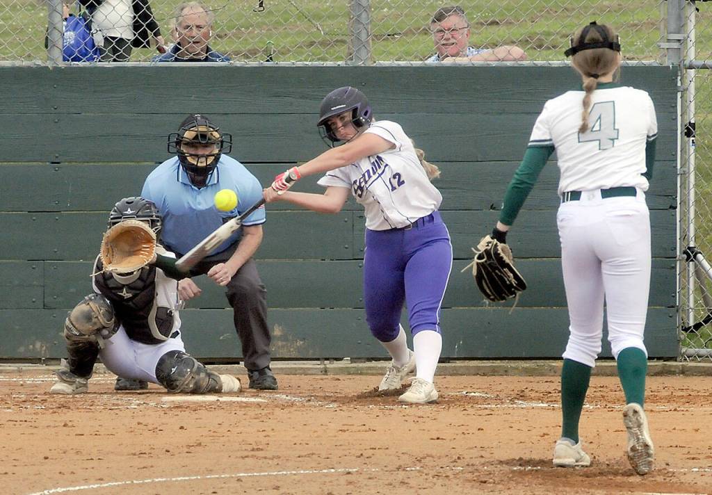 Sequims Michaela Green swings at a pitch from Port Angeles Teagan Clark as catcher Zoe Smithson waits for the delivery on Friday in Port Angeles. (Keith Thorpe/Peninsula Daily News)