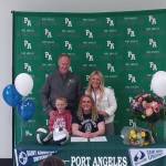 Kennedy Bruch signs a letter of intent to play volleyball and run track at St. Augustine's College in Raleigh, N.C. with her father Jesse Bruch, mother Alissa Bruch and brother Jack Bruch. (Pierre LaBossiere/Peninsula Daily News)